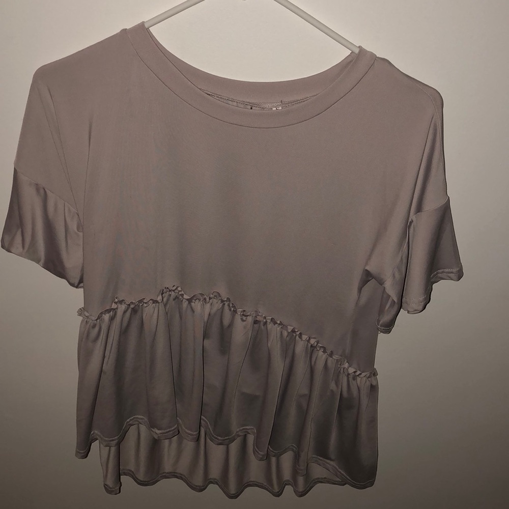 a pink stretchy blouse that has ruffles